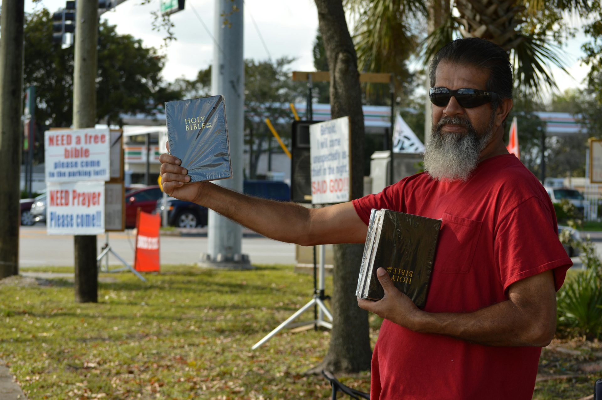 Portrait of a Bearded Man Handing Out Free Bibles