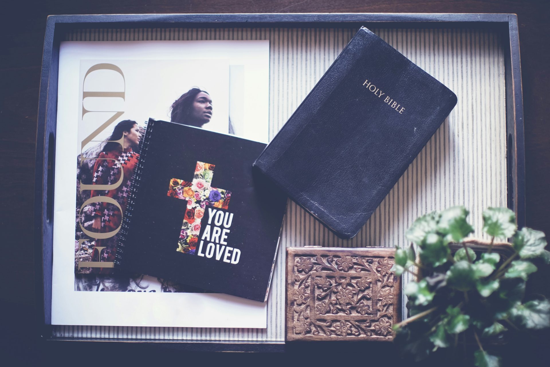 Bible and devotional notebook on tray.