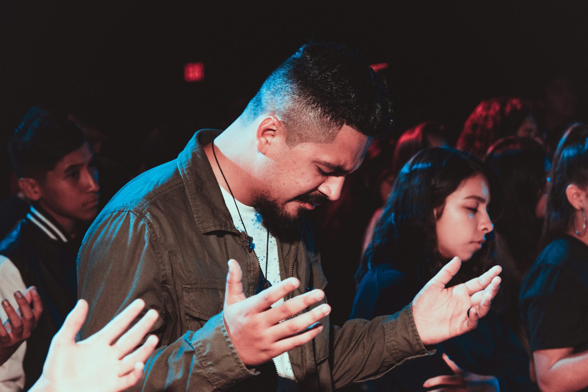 Man praying passionately during a service.